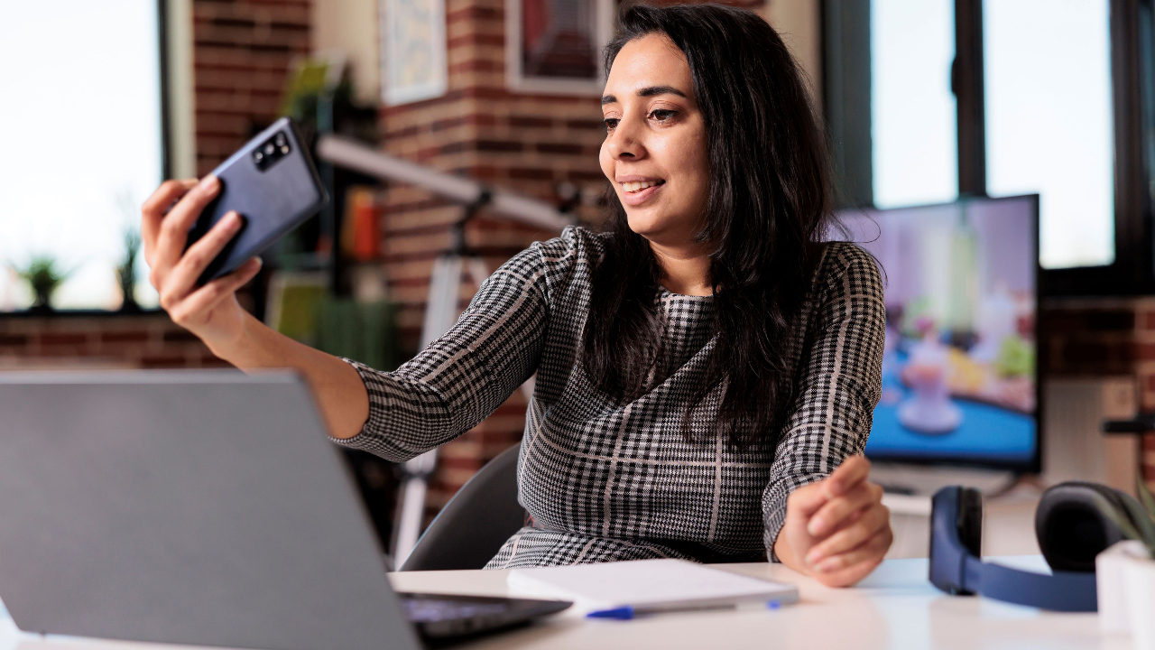 Woman talking on a cellphone in her office